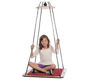 Product photo of a girl sitting cross-legged on a flat square platform swing