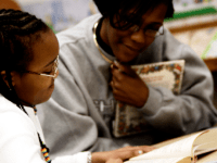 Woman and girl reading together