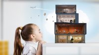 A young girl imagines that a pile of small boxes on a table are a house complete with electricity, with a plane and hot-air balloons flying above.