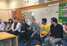 A group of teachers and support providers discuss a community walk in Oakland.