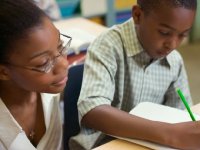 Teacher watching while a student writes