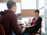 photo of two people seated across from one another