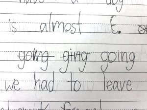 A sample of student work in pen from the writer’s class, showing a misspelled word crossed out and corrected
