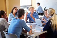 rhetorical analysis ads High school students discussing advertisements in a group in the classroom