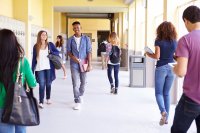 High school students walking around in a school hallway