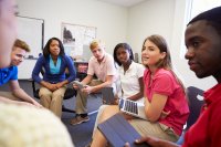 Students sitting in a circle, discussing their reading assignment