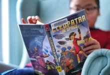 Elementary student reads a graphic novel at home