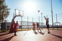 Four men playing basketball. One is shooting a free throw.