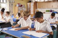 Students doing schoolwork in a middle school English classroom