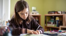 Adolescent girl doing homework.