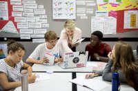 Group of students learning in classroom