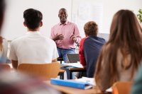 Administrator teaching a high school class