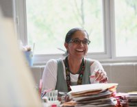 Teacher smiling at her desk