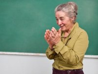 photo of a woman in front of a chalkboard