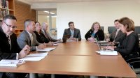 photograph of people around a conference room table