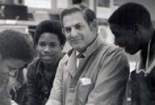 Old picture of man with student in shop class