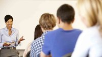 A teacher discusses a text with her students.