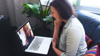 Two women talking via video chat on a laptop