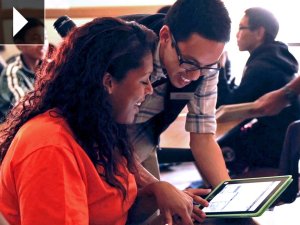 Mariah, a student intern at the California Academy of Sciences, looks over materials with a mentor.