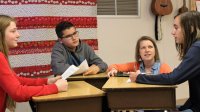 Katie Dulaney listens as her students have a discussion.