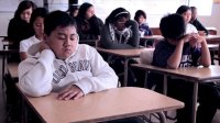 Children quietly sitting at their desks with eyes closed