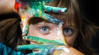 Photo of a girl with paint on both hands