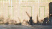 A shadow of a young boy is shown against a brick wall.