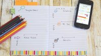 Image of a student’s open daily planner with colored pencils and smartphone calendar on the side