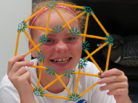 photo of a young woman with a spirograph-like toy