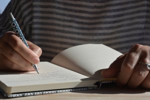 Teacher writing in a journal