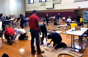 Students and teachers working in the gym