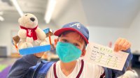 Student proudly holding his stuffed animal project