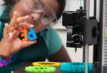 Photo of student working with 3D printer