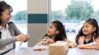 Elementary teacher has lunch with two students