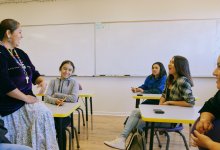 Students engage happily with teacher during math class