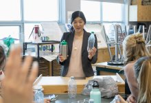 Teacher explains recycling to science class