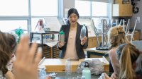 Teacher explains recycling to science class