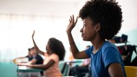 Black student raises her hand in class