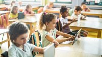 Photo of first graders on tablet in classroom