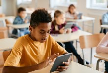 Photo of middle school students with tablets