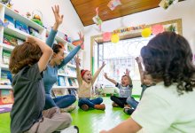Preschool teacher leading class in a song