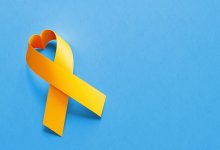 Yellow ribbon in the shape of a heart on a blue background