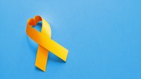 Yellow ribbon in the shape of a heart on a blue background