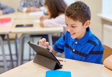 Elementary student using a tablet in class