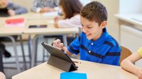 Elementary student using a tablet in class