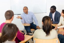 Teacher leading a meeting in a classroom