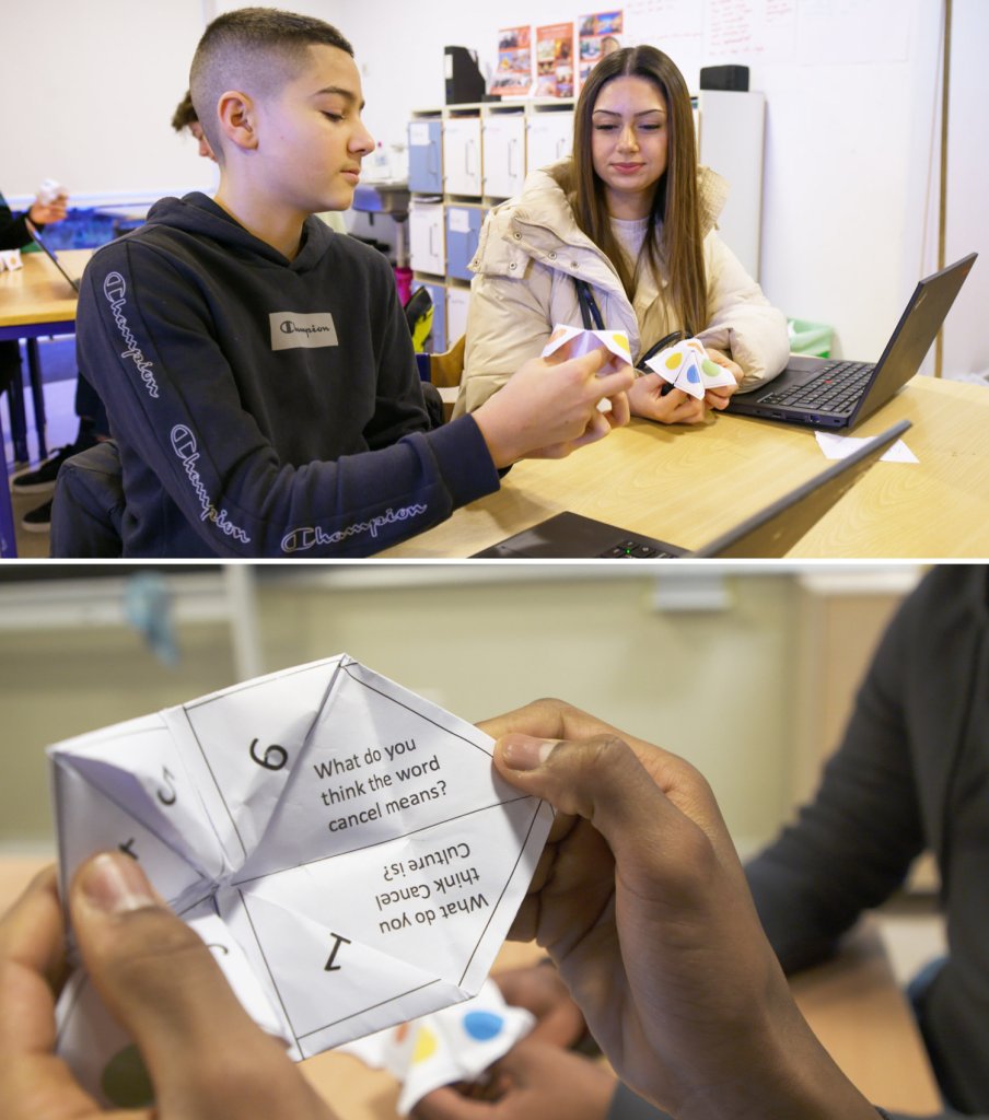 Two students with fortune teller game in class