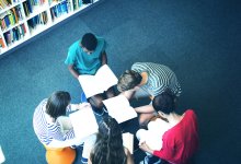 Photo of high school students reading books