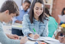 Middle school students writing and working together