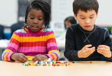 Two elementary students working with manipulatives